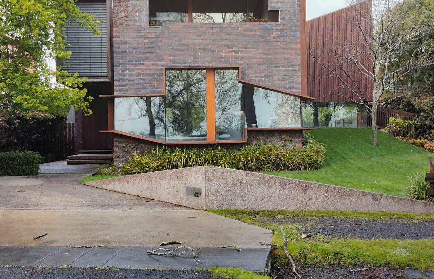 Perth property exterior showing driveway access and landscaped site levels